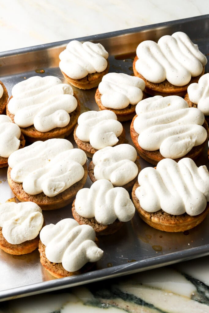 mascarpone cream piped on top of donuts