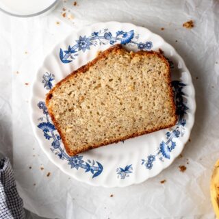 one slice of banana bread on a plate with milk