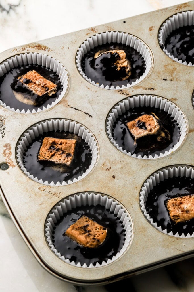chocolate cupcake batter with espresso soaked lady finger in the middle
