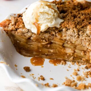 dutch apple pie cut into with ice cream and caramel on top