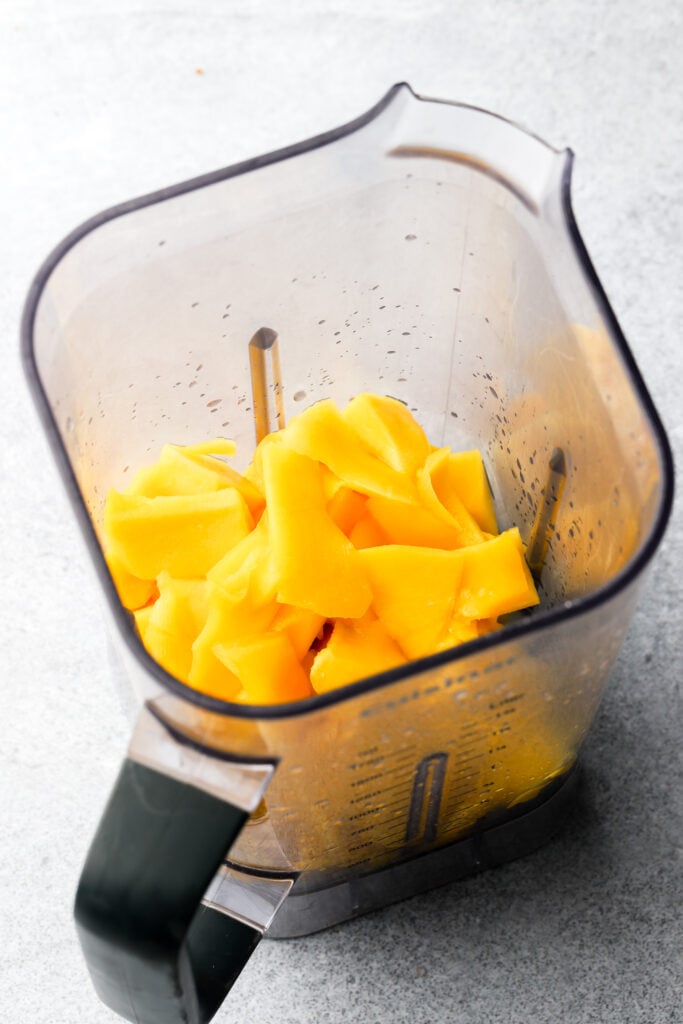 fresh mango chunks in a blender