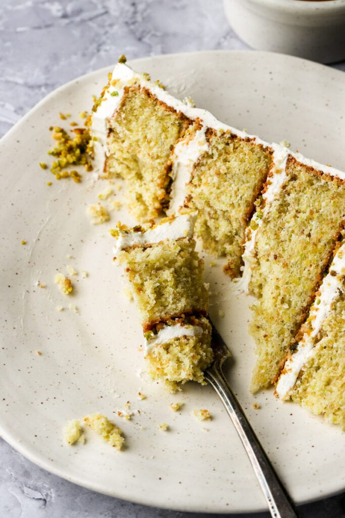 a bite taken out of a pistachio cake