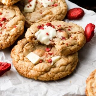 strawberry white chocolate chip cookies on a sheet of parchment paper