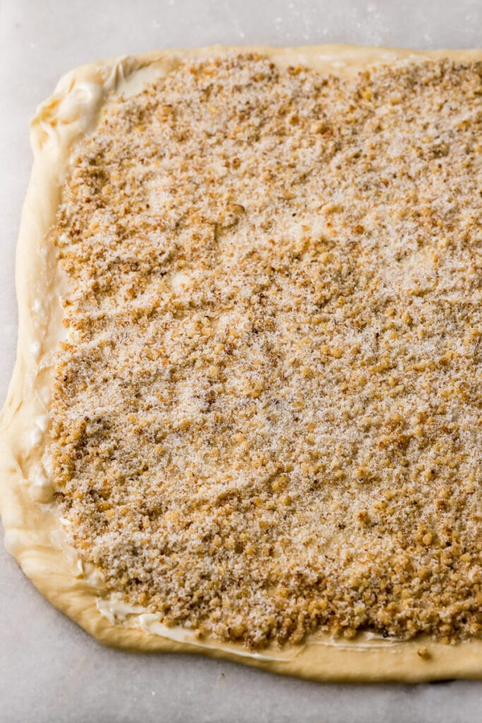 dough rolled out with filling on top 